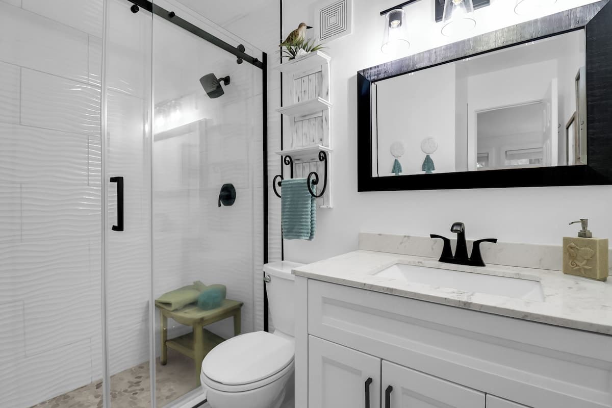 Master bath with custom tile-floored walk-in shower and quartz vanity