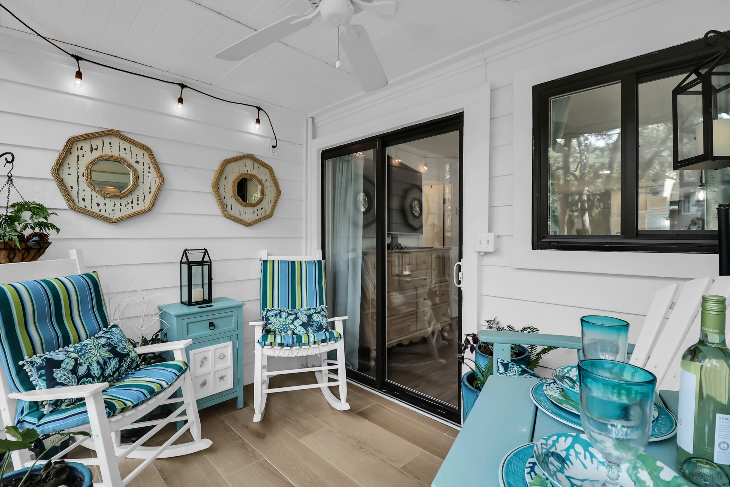 Screened porch with rocking chairs and coastal decor